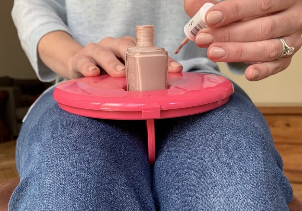 Nailpad provides flat, stable surface with polish pot holder for self manicures and pedicures